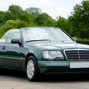 A vintage Mercedes-Benz convertible parked outdoors during a bright day in the UK.